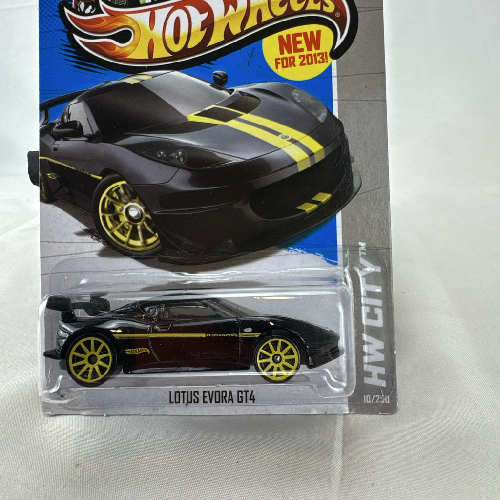 Hot Wheels 1:64 scale Lotus Evora GT4 diecast car in black with yellow stripes, factory sealed on original card