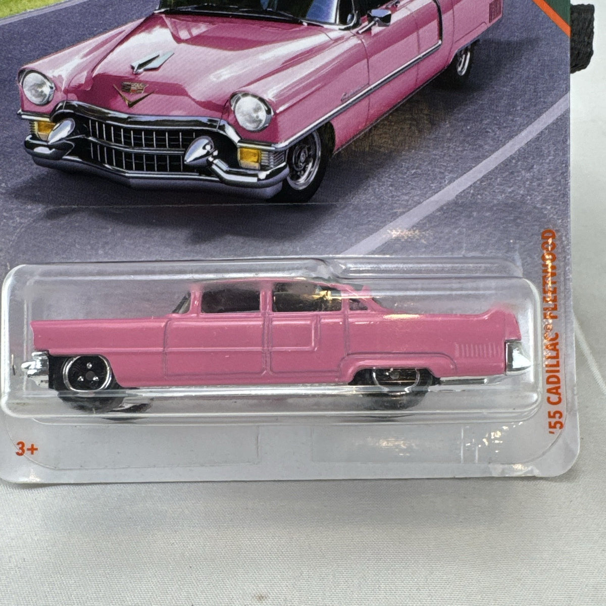 Matchbox 1:64 scale 1955 Cadillac Fleetwood diecast car in pink with grey roof sealed on original backing card.