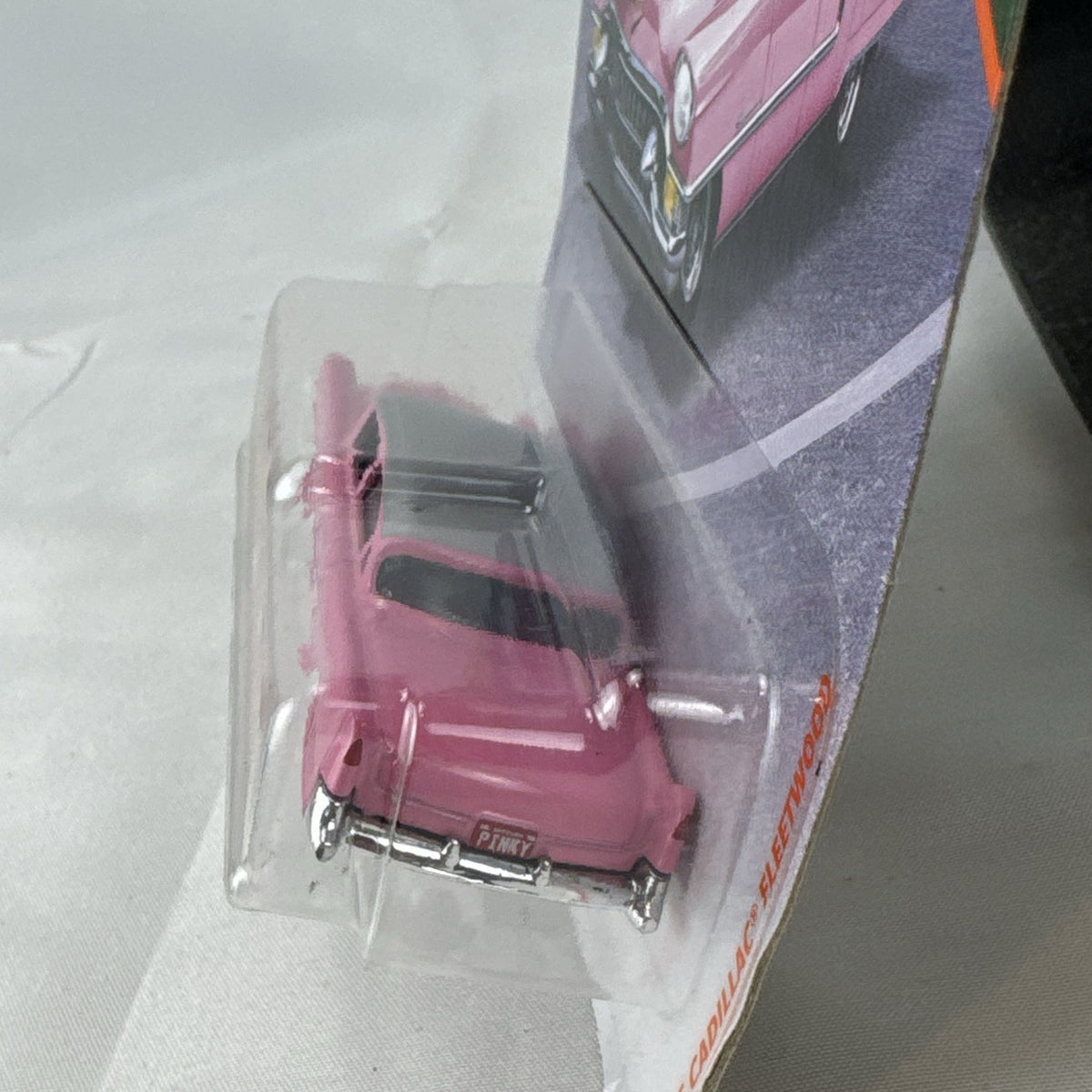 Matchbox 1:64 scale 1955 Cadillac Fleetwood diecast car in pink with grey roof sealed on original backing card.