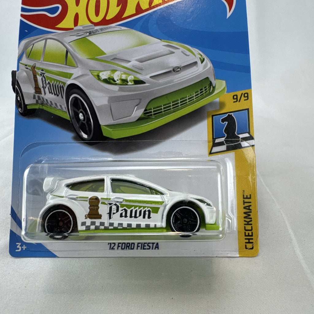 Hot Wheels 1:64 scale 2012 Ford Fiesta diecast car in white with green Pawn Checkmate graphics, sealed on card.