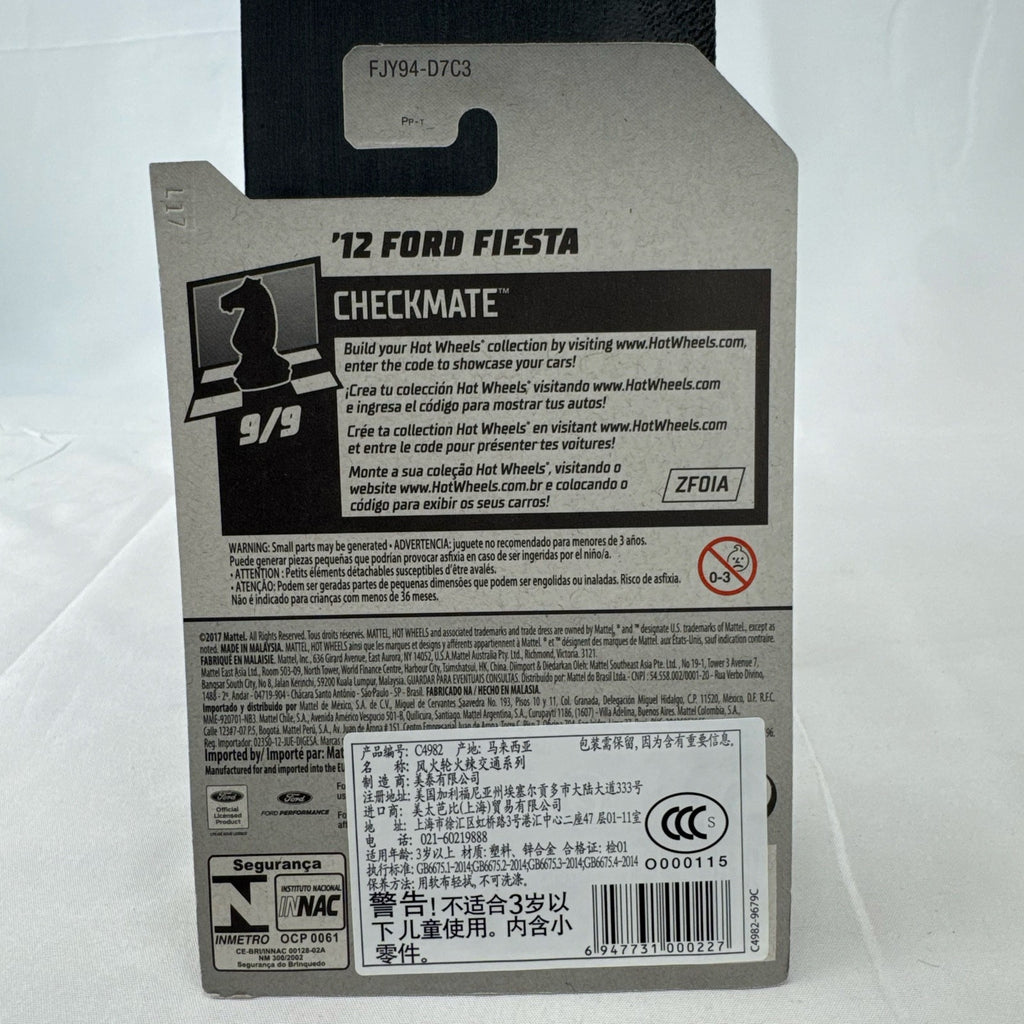 Hot Wheels 1:64 scale 2012 Ford Fiesta diecast car in white with green Pawn Checkmate graphics, sealed on card.