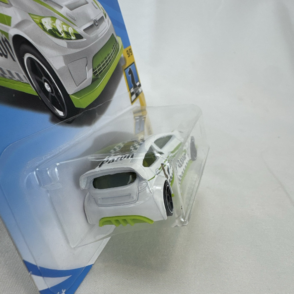 Hot Wheels 1:64 scale 2012 Ford Fiesta diecast car in white with green Pawn Checkmate graphics, sealed on card.