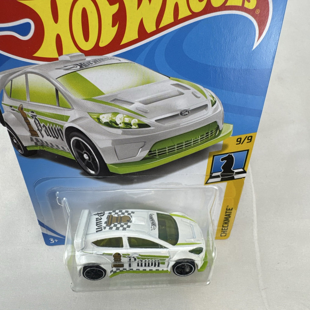 Hot Wheels 1:64 scale 2012 Ford Fiesta diecast car in white with green Pawn Checkmate graphics, sealed on card.