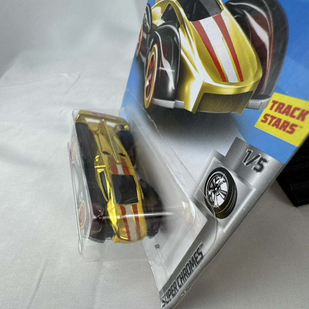 Factory sealed Hot Wheels ElecTrack 1:64 diecast car in gold chrome with red and white racing stripes on original card.
