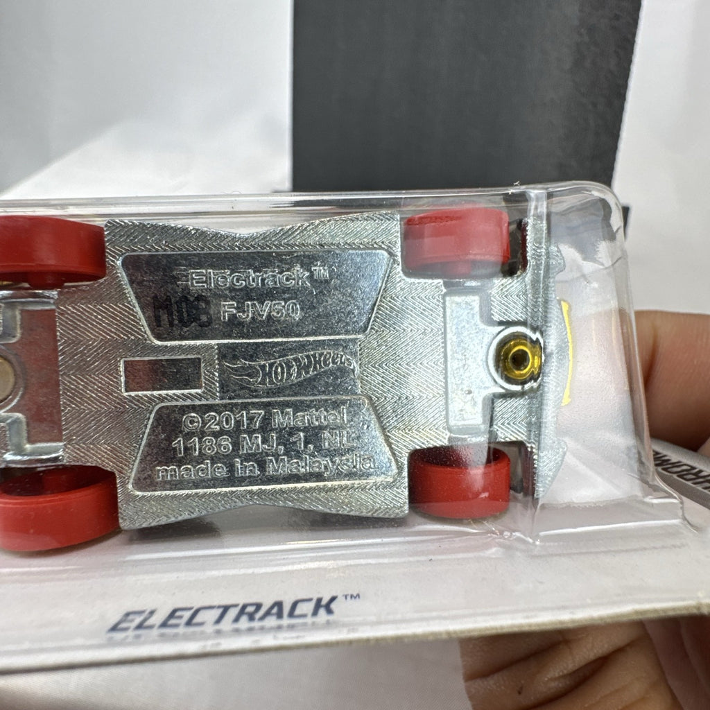 Factory sealed Hot Wheels ElecTrack 1:64 diecast car in gold chrome with red and white racing stripes on original card.