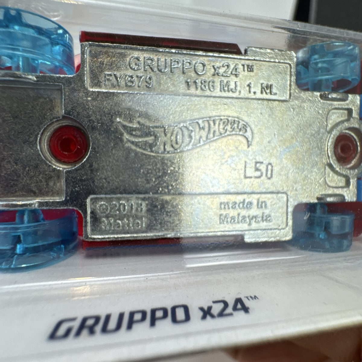 Hot Wheels Gruppo x24 1:64 scale diecast car in translucent red on original blister card