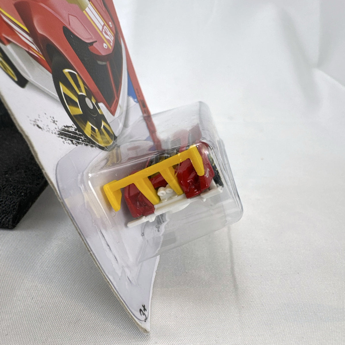 Hot Wheels Super Blitzen diecast car in red with yellow racing stripes and yellow spoiler in original blister package.