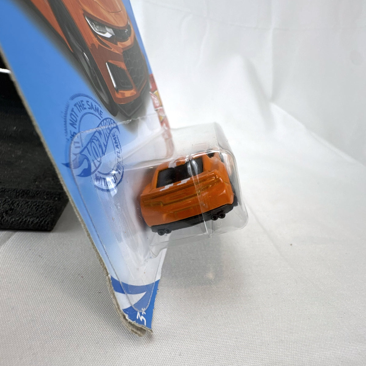 Carded Hot Wheels 1:64 scale 2017 Chevrolet Camaro ZL1 diecast car in orange with white racing stripes