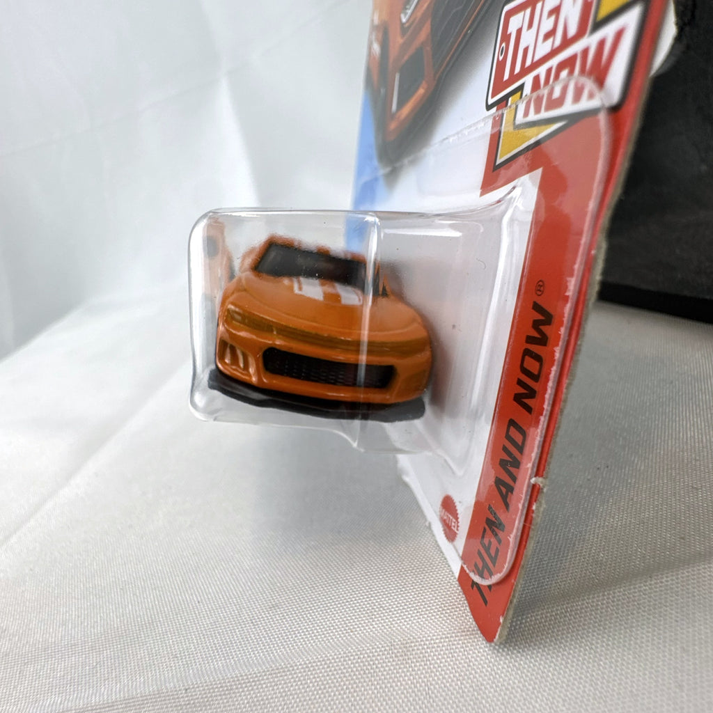 Carded Hot Wheels 1:64 scale 2017 Chevrolet Camaro ZL1 diecast car in orange with white racing stripes