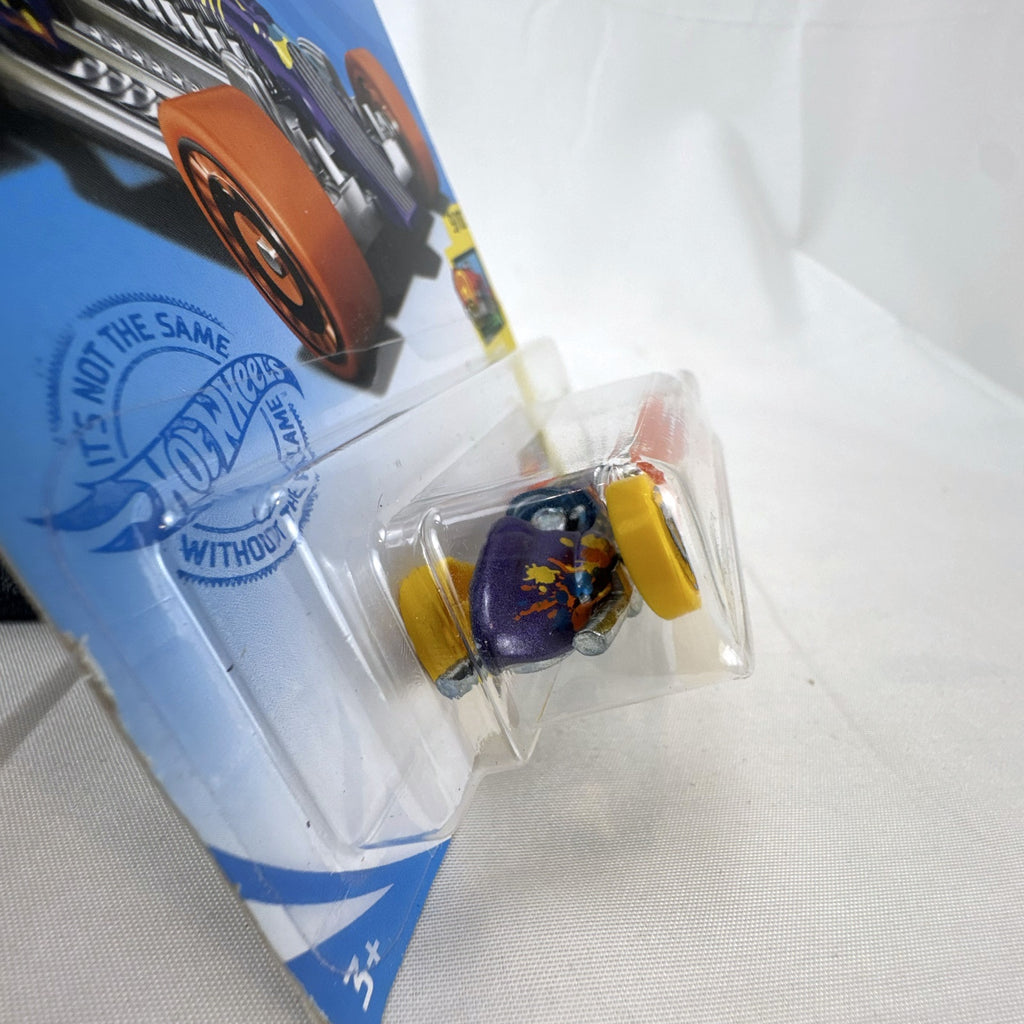 Hot Wheels 1:64 scale Rocket Oil Special diecast streamliner in purple art splatter card packaging