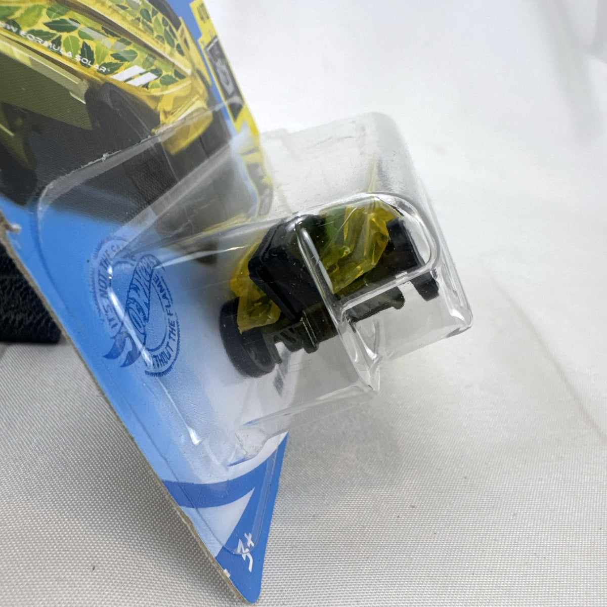 Hot Wheels 1:64 scale HW Formula Solar diecast car in translucent yellow on original sealed blister card.