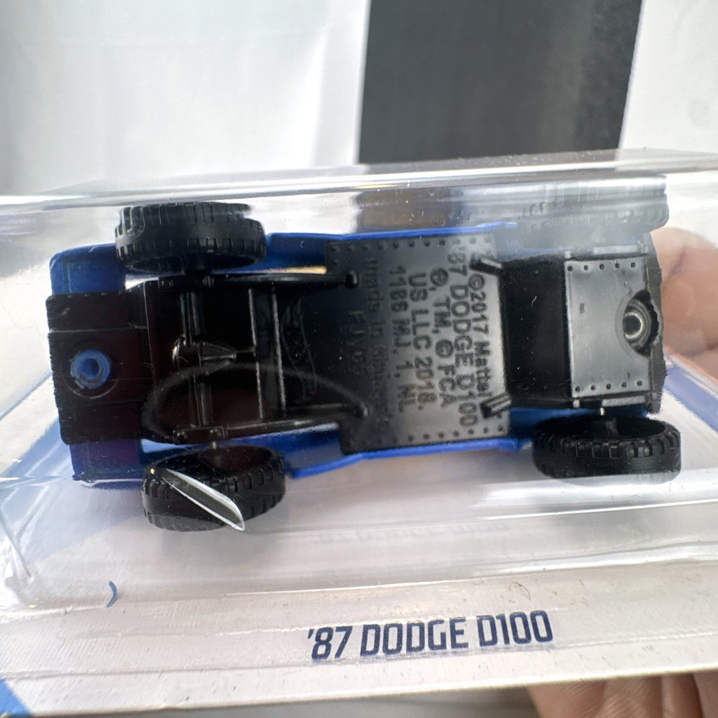 Hot Wheels 1987 Dodge D100 pickup truck in Race Team blue on blister card