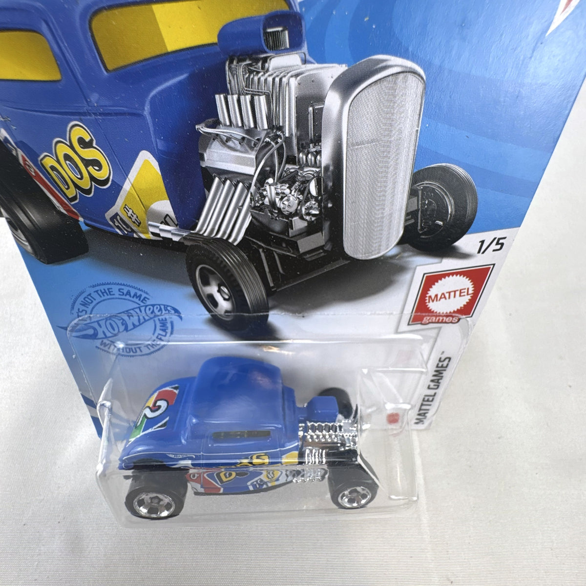Sealed Hot Wheels 1932 Ford Coupe diecast car in blue with Mattel Games DOS card game graphics on original blister card.