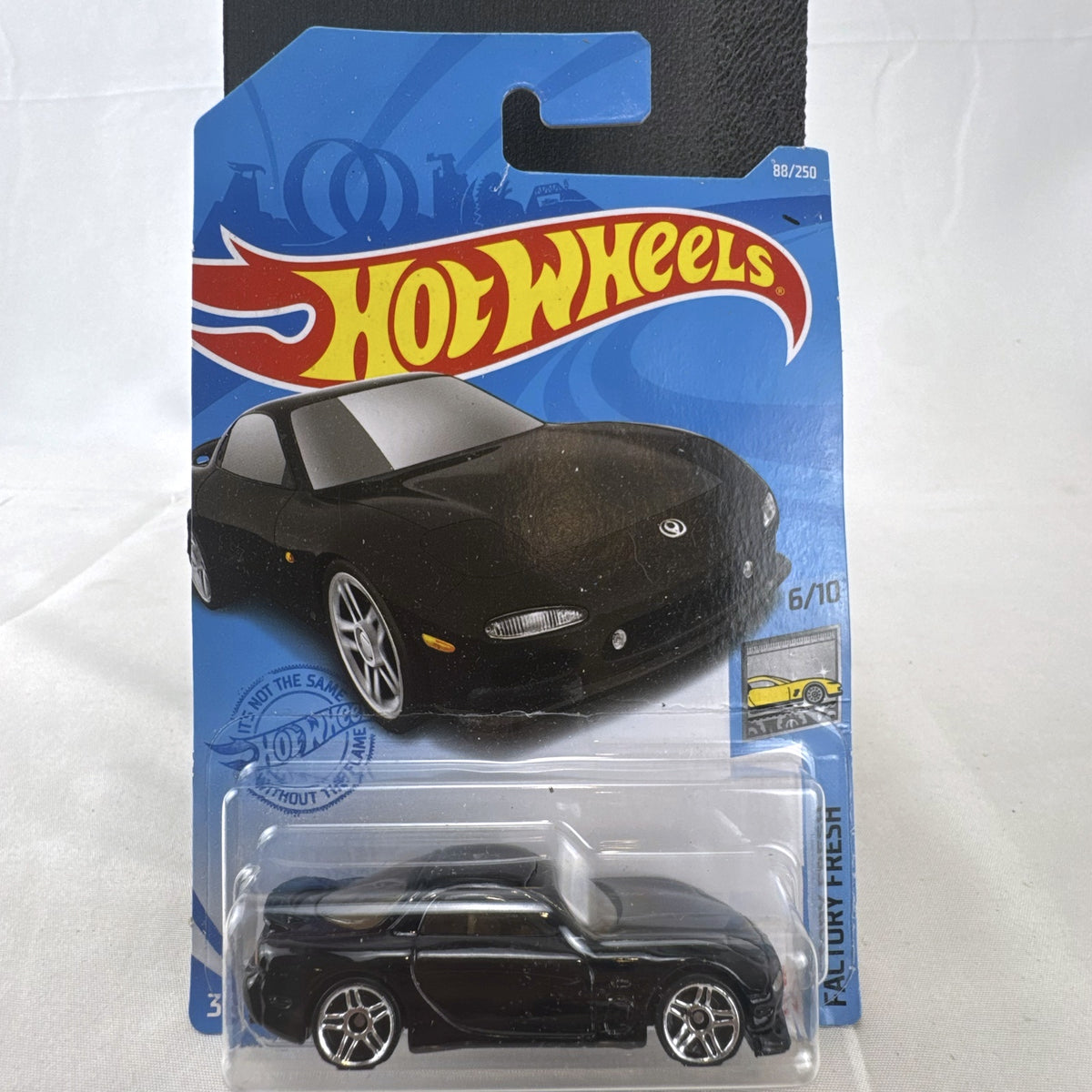 Hot Wheels 1995 Mazda RX-7 diecast 1:64 scale model car in black, sealed in original blister packaging.