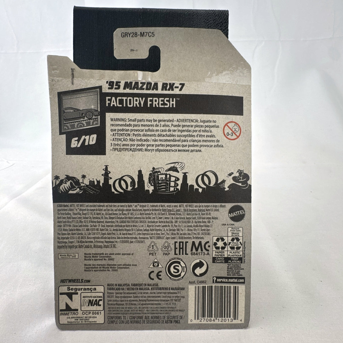 Hot Wheels 1995 Mazda RX-7 diecast 1:64 scale model car in black, sealed in original blister packaging.