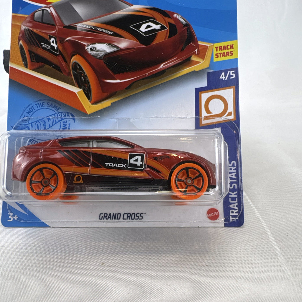 Sealed 1:64 scale Hot Wheels Grand Cross diecast car in metallic red with orange wheels and track stars graphics.