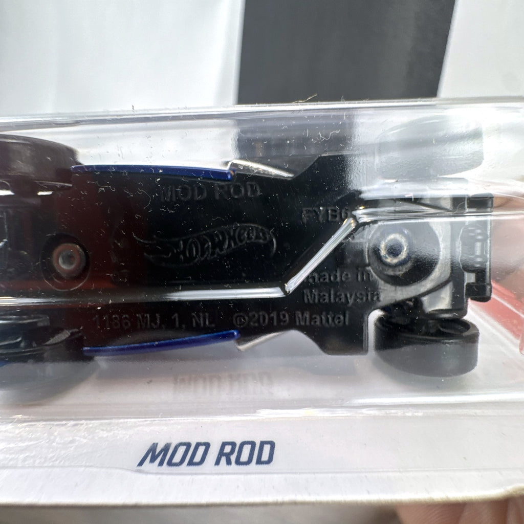 Hot Wheels Mod Rod 1:64 diecast car in blue with yellow and orange HW Flames graphics, sealed on card.