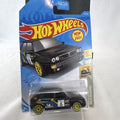 Hot Wheels 1:64 scale 1994 Lancia Delta Integrale diecast rally car in black with yellow wheels, sealed in package