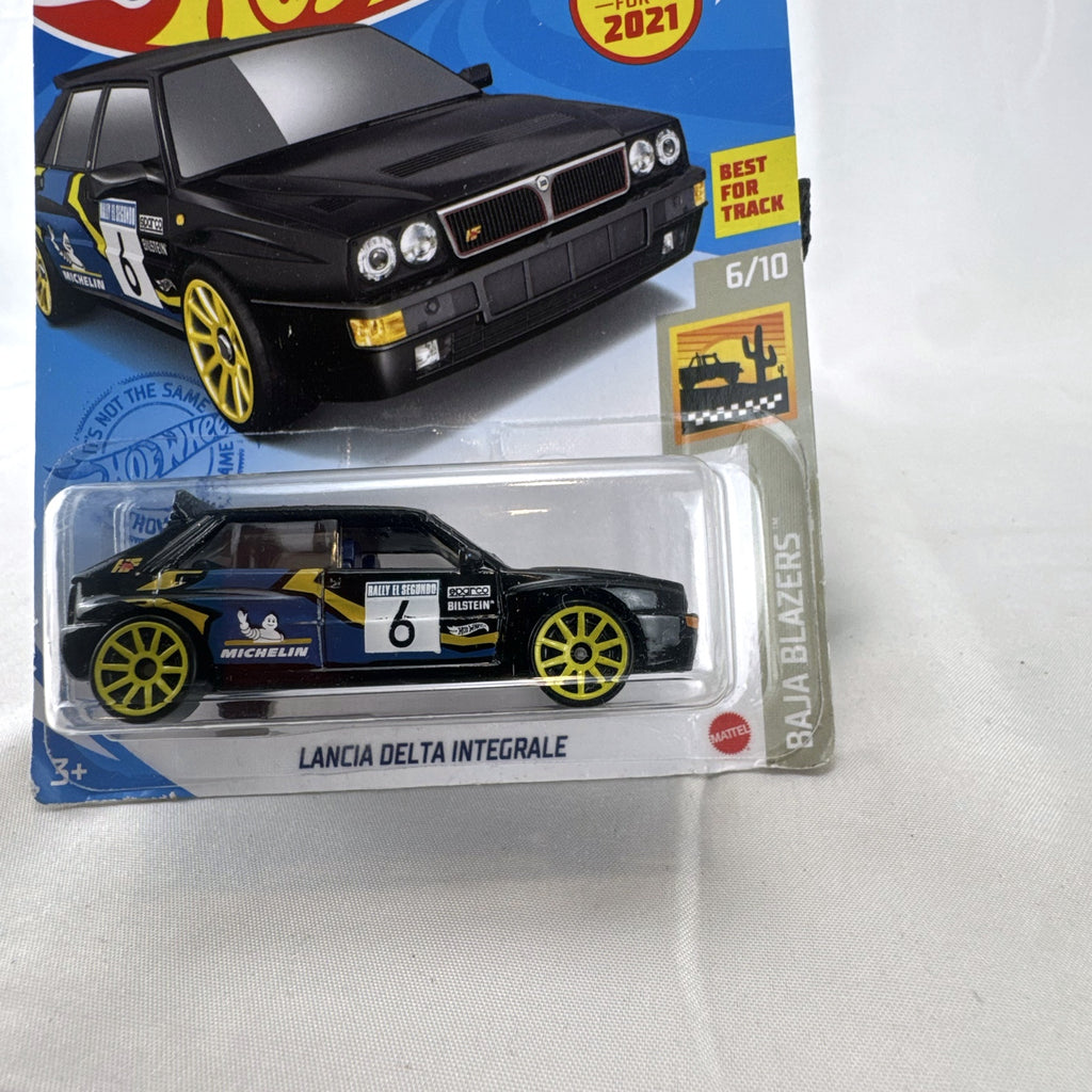 Hot Wheels 1:64 scale 1994 Lancia Delta Integrale diecast rally car in black with yellow wheels, sealed in package