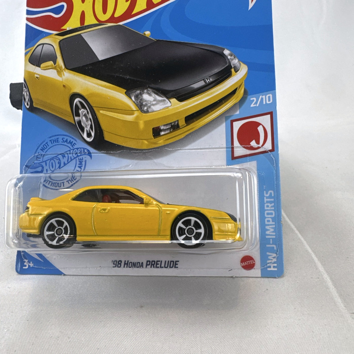 Hot Wheels 1:64 scale 1998 Honda Prelude diecast car in bright yellow with black hood on packaging