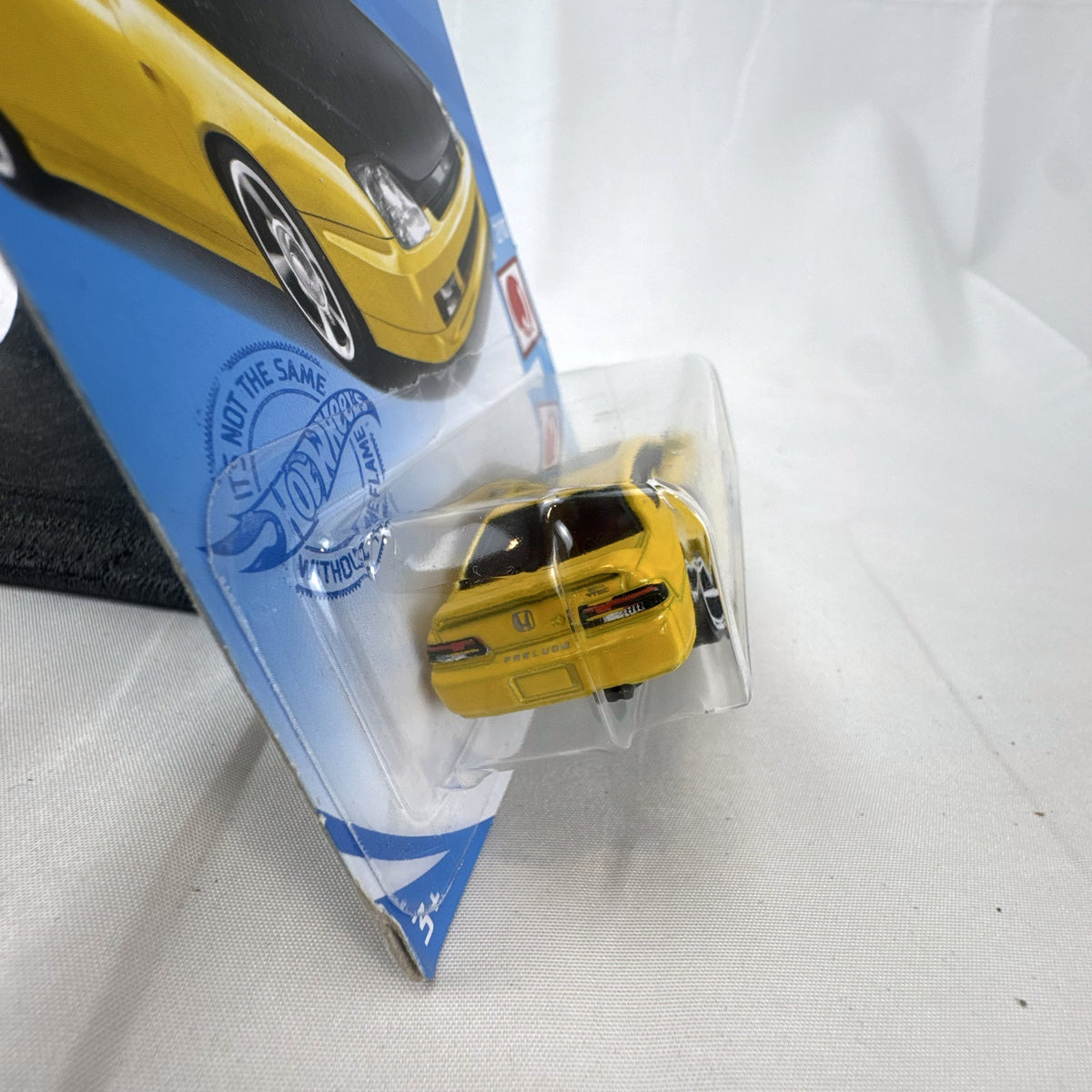 Hot Wheels 1:64 scale 1998 Honda Prelude diecast car in bright yellow with black hood on packaging
