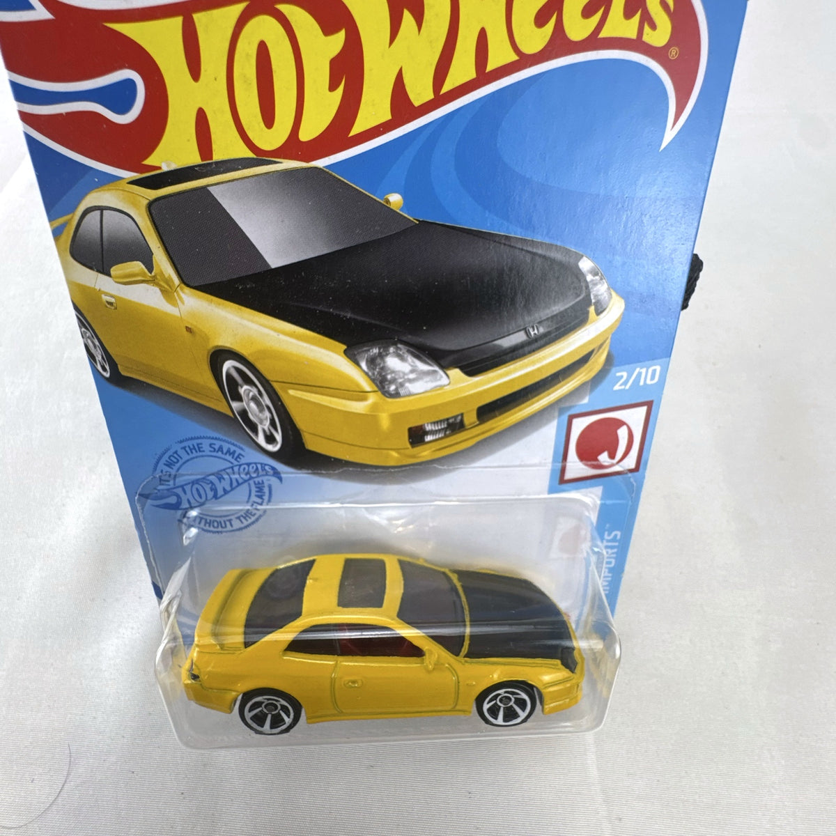 Hot Wheels 1:64 scale 1998 Honda Prelude diecast car in bright yellow with black hood on packaging