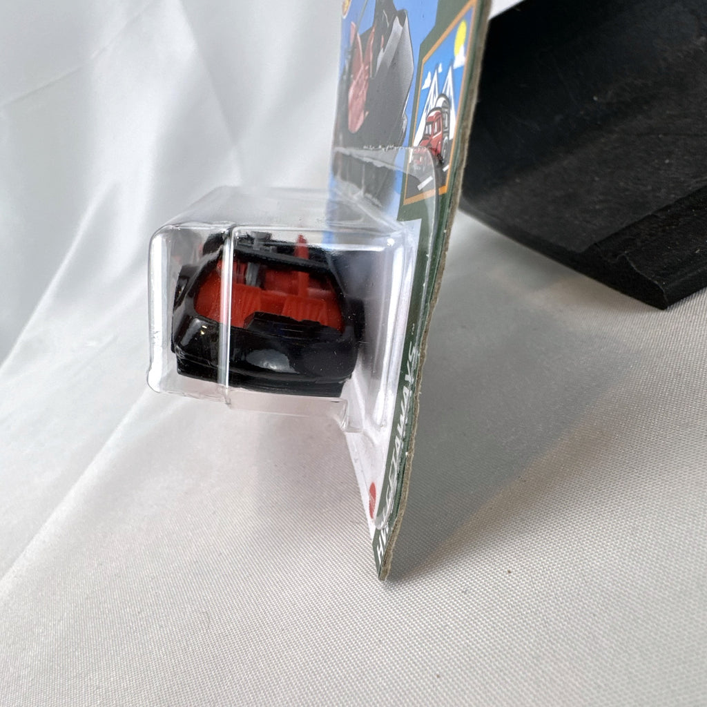 Hot Wheels Deora III 1:64 scale diecast car in black on factory-sealed international short card packaging
