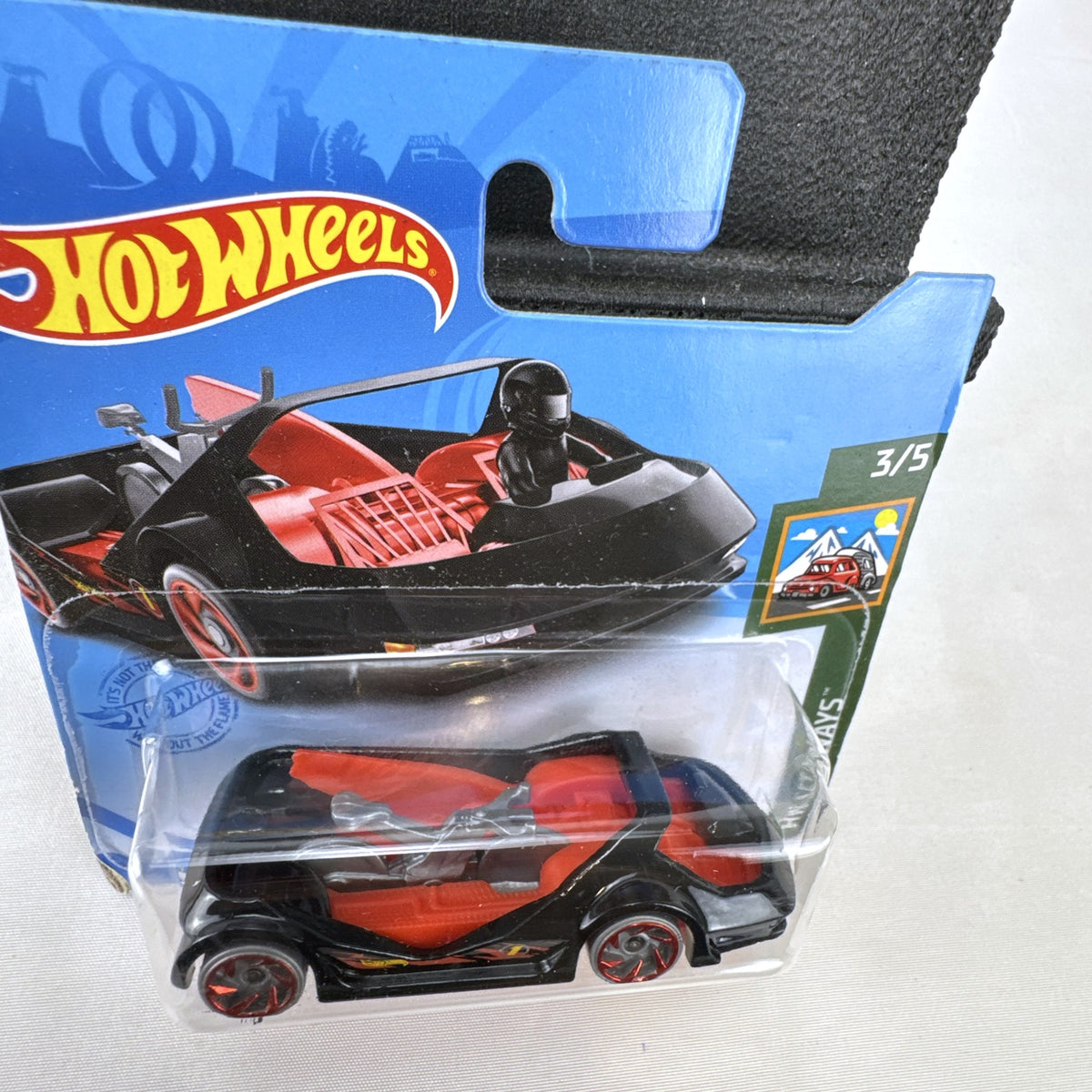 Hot Wheels Deora III 1:64 scale diecast car in black on factory-sealed international short card packaging