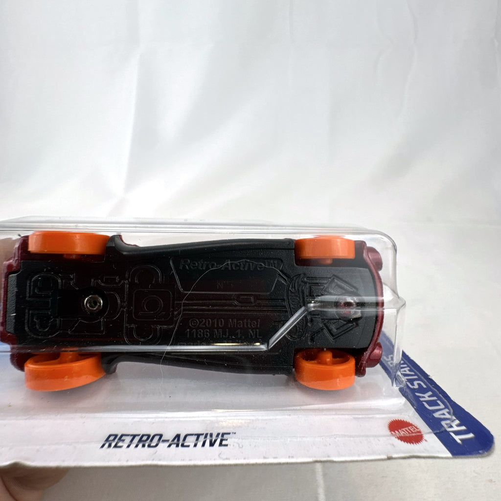 Hot Wheels Retro-Active diecast car in metallic maroon on original Track Stars blister card packaging.