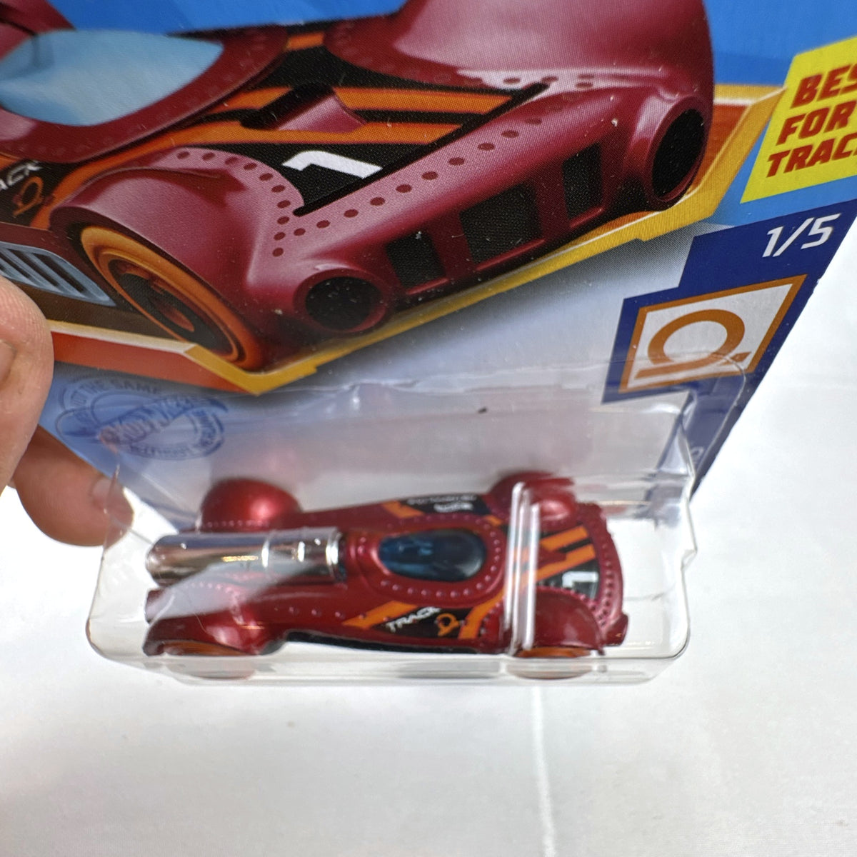 Hot Wheels Retro-Active diecast car in metallic maroon on original Track Stars blister card packaging.