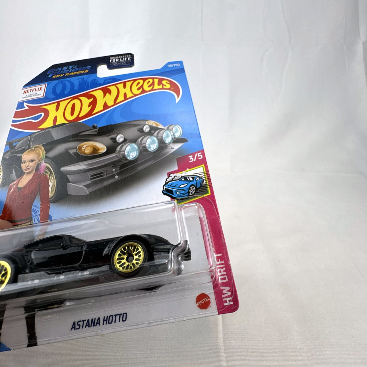 Hot Wheels Astana Hotto 1:64 scale diecast car in black with gold rims, sealed on Fast & Furious Spy Racers card