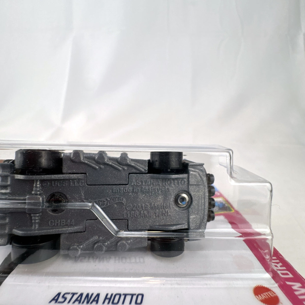 Hot Wheels Astana Hotto 1:64 scale diecast car in black with gold rims, sealed on Fast & Furious Spy Racers card