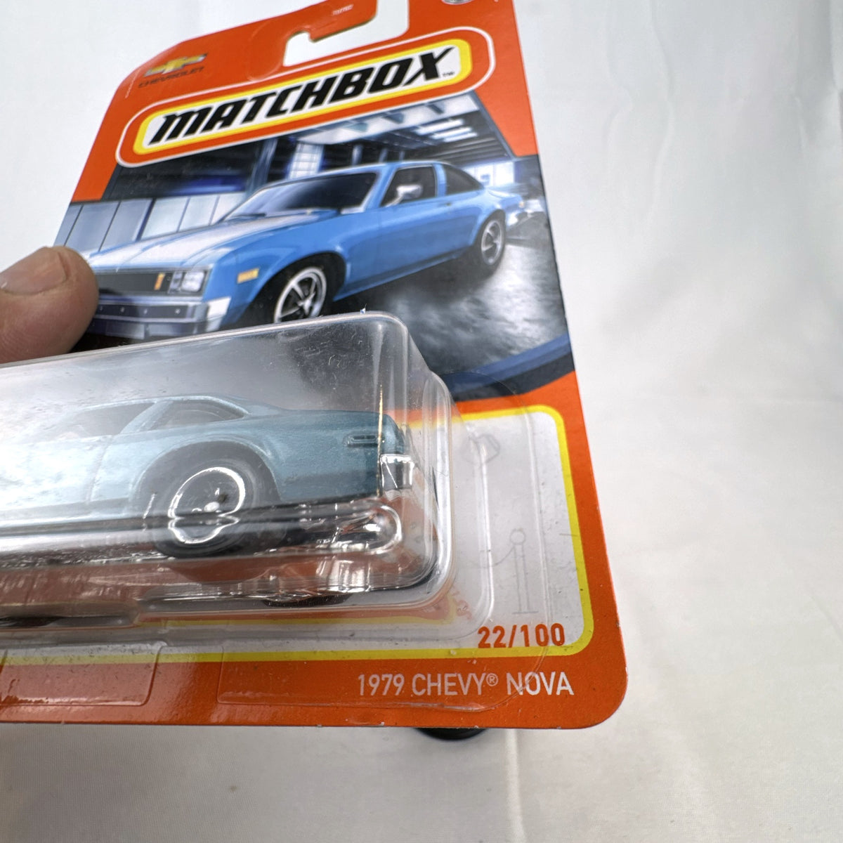 Matchbox 1979 Chevrolet Nova 1:64 scale diecast car in metallic blue with white hood stripes
