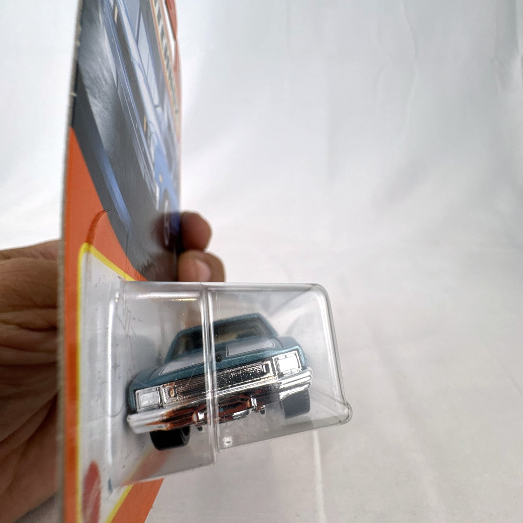 Matchbox 1979 Chevrolet Nova 1:64 scale diecast car in metallic blue with white hood stripes