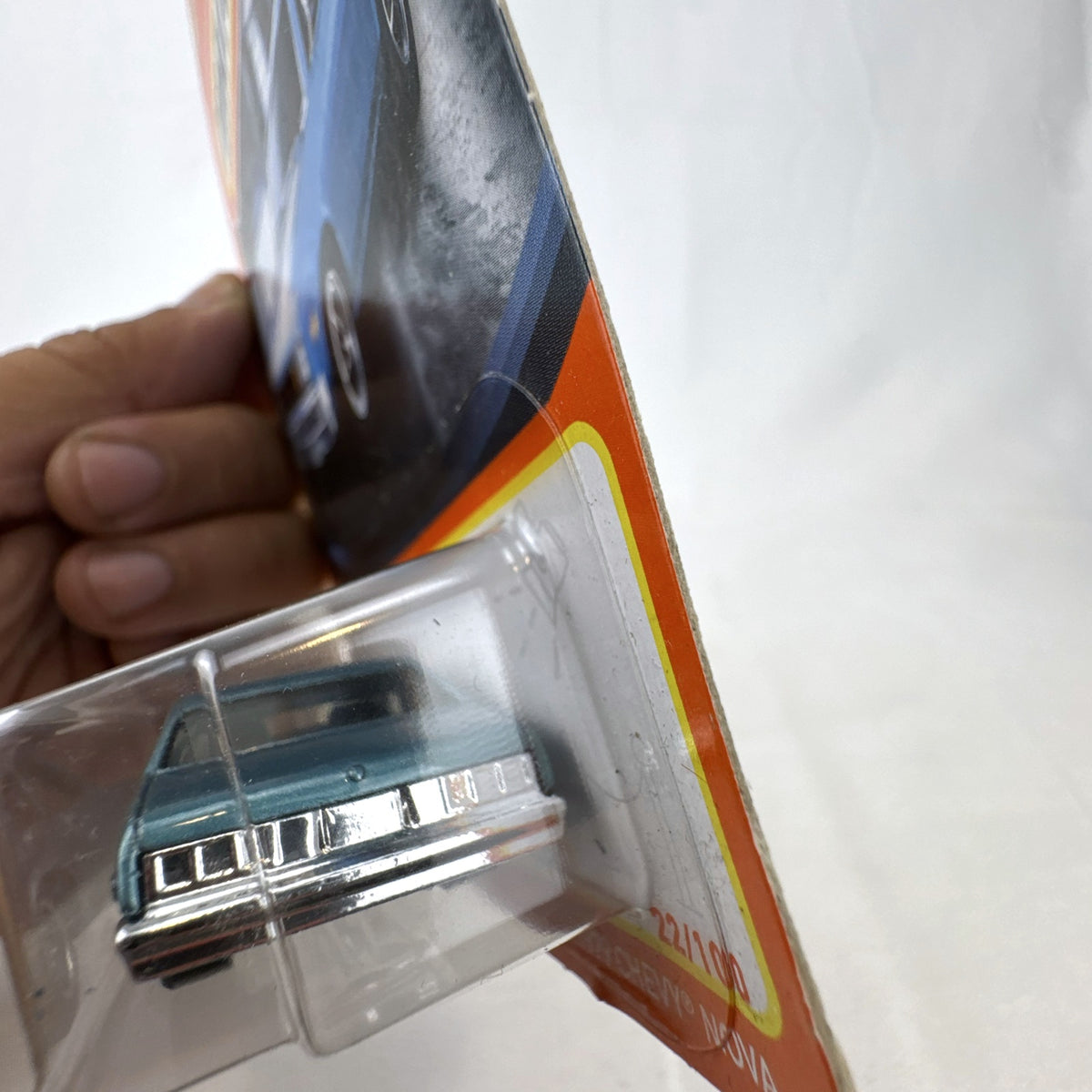 Matchbox 1979 Chevrolet Nova 1:64 scale diecast car in metallic blue with white hood stripes