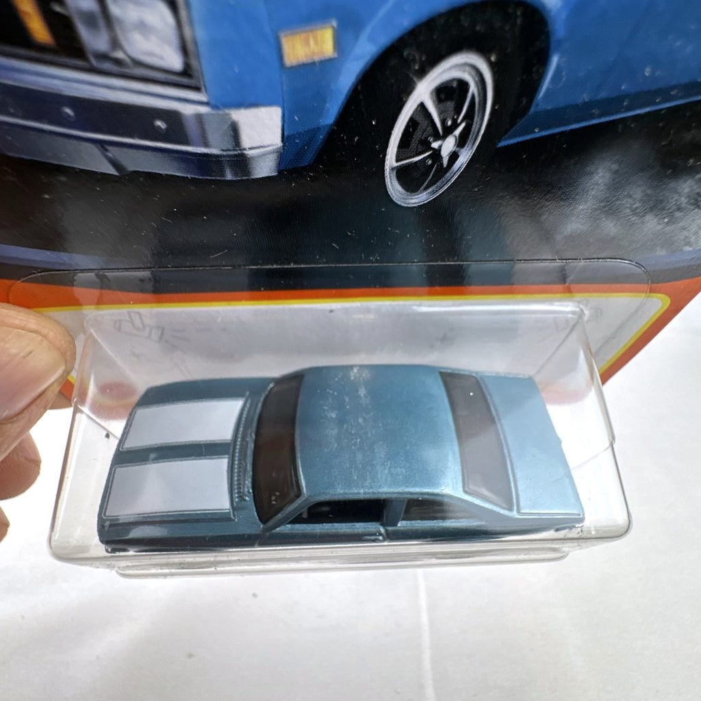 Matchbox 1979 Chevrolet Nova 1:64 scale diecast car in metallic blue with white hood stripes