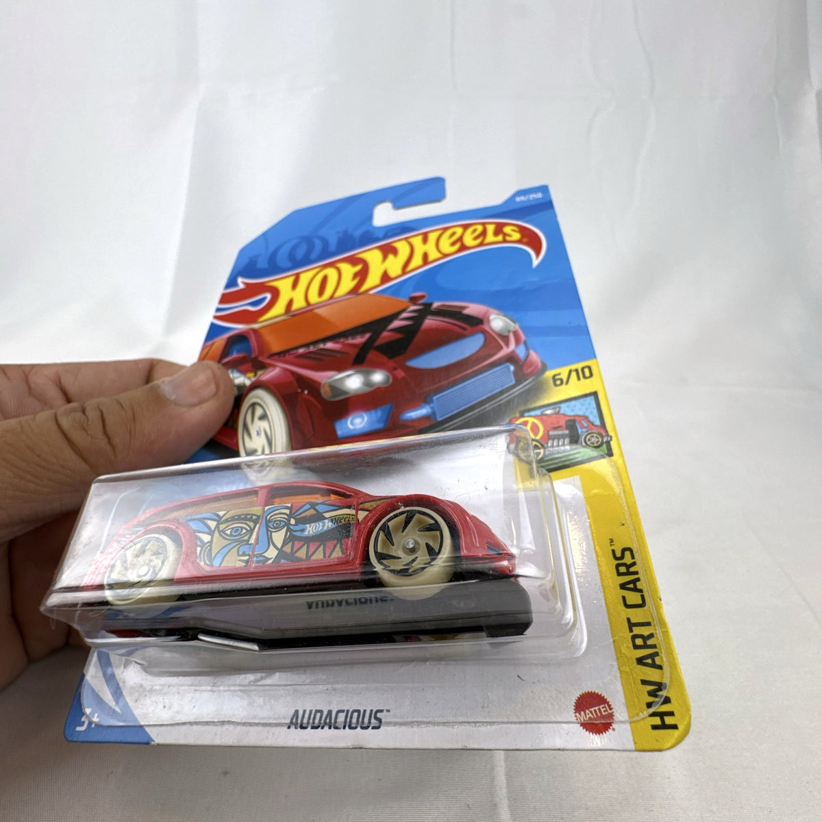 Hot Wheels 1:64 scale Audacious diecast wagon in red with HW Art Cars graphics sealed on card