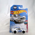 White Hot Wheels 1:64 scale Mazda RX-3 diecast car in Mad Mike HW Drift livery sealed on card.