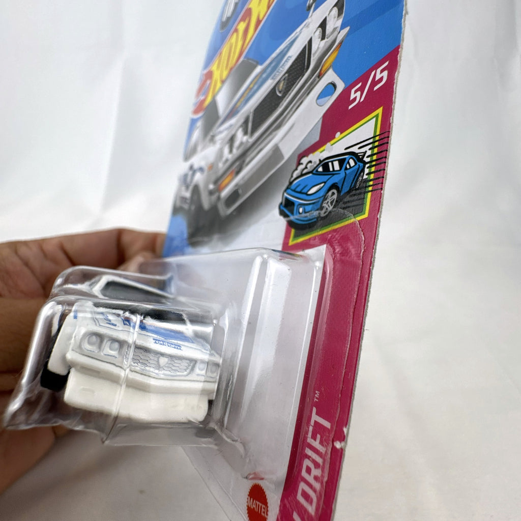 White Hot Wheels 1:64 scale Mazda RX-3 diecast car in Mad Mike HW Drift livery sealed on card.