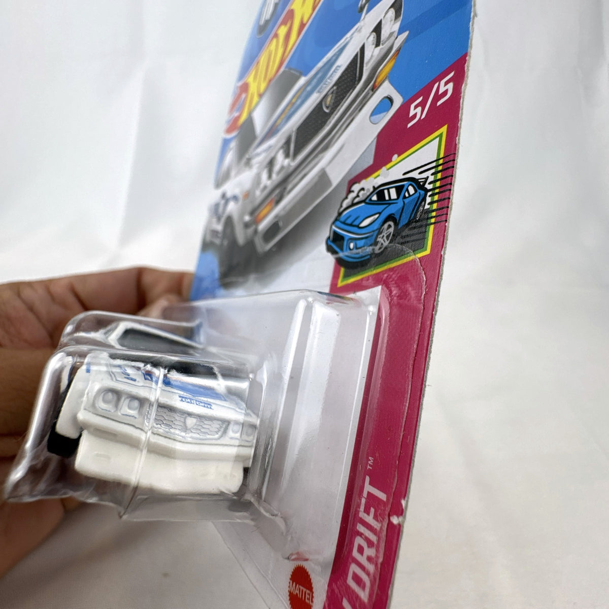 White Hot Wheels 1:64 scale Mazda RX-3 diecast car in Mad Mike HW Drift livery sealed on card.