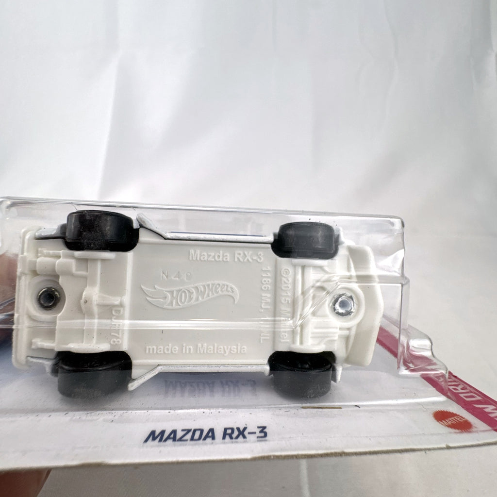 White Hot Wheels 1:64 scale Mazda RX-3 diecast car in Mad Mike HW Drift livery sealed on card.