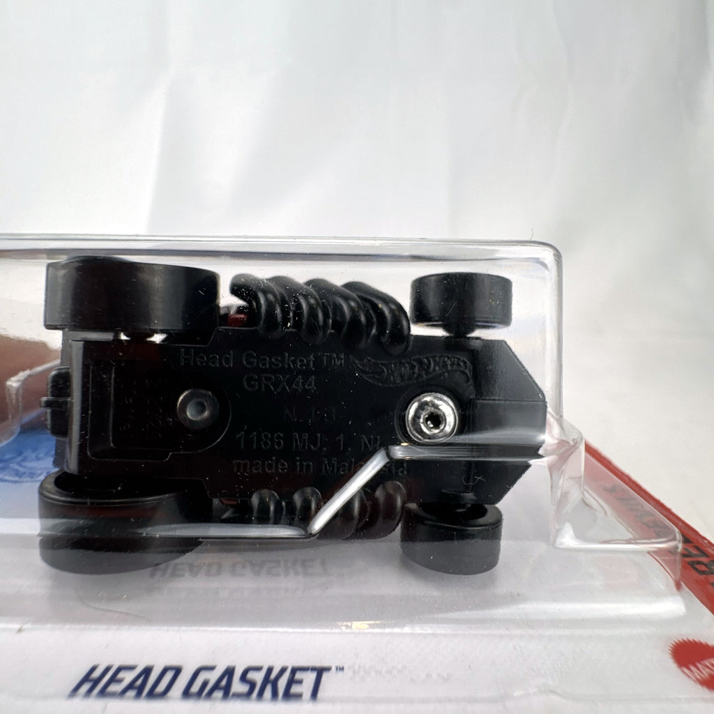 Hot Wheels Head Gasket 2021 HW Daredevils metallic red diecast car in unopened packaging.