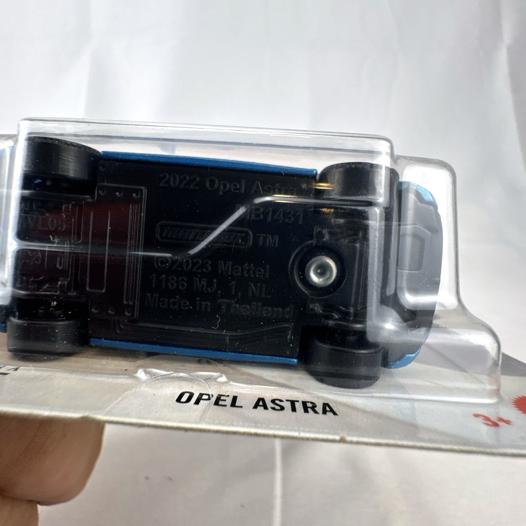 Matchbox 2022 Opel Astra 1:64 scale diecast car in metallic blue with black roof, factory sealed on blister card