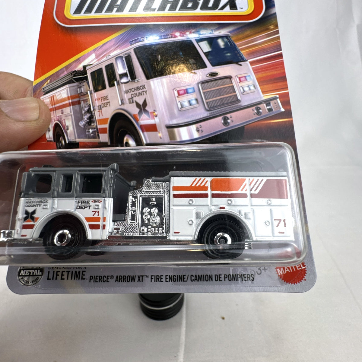 Matchbox Pierce Arrow XT Fire Engine diecast truck in white and grey, factory sealed on original card 104/125.