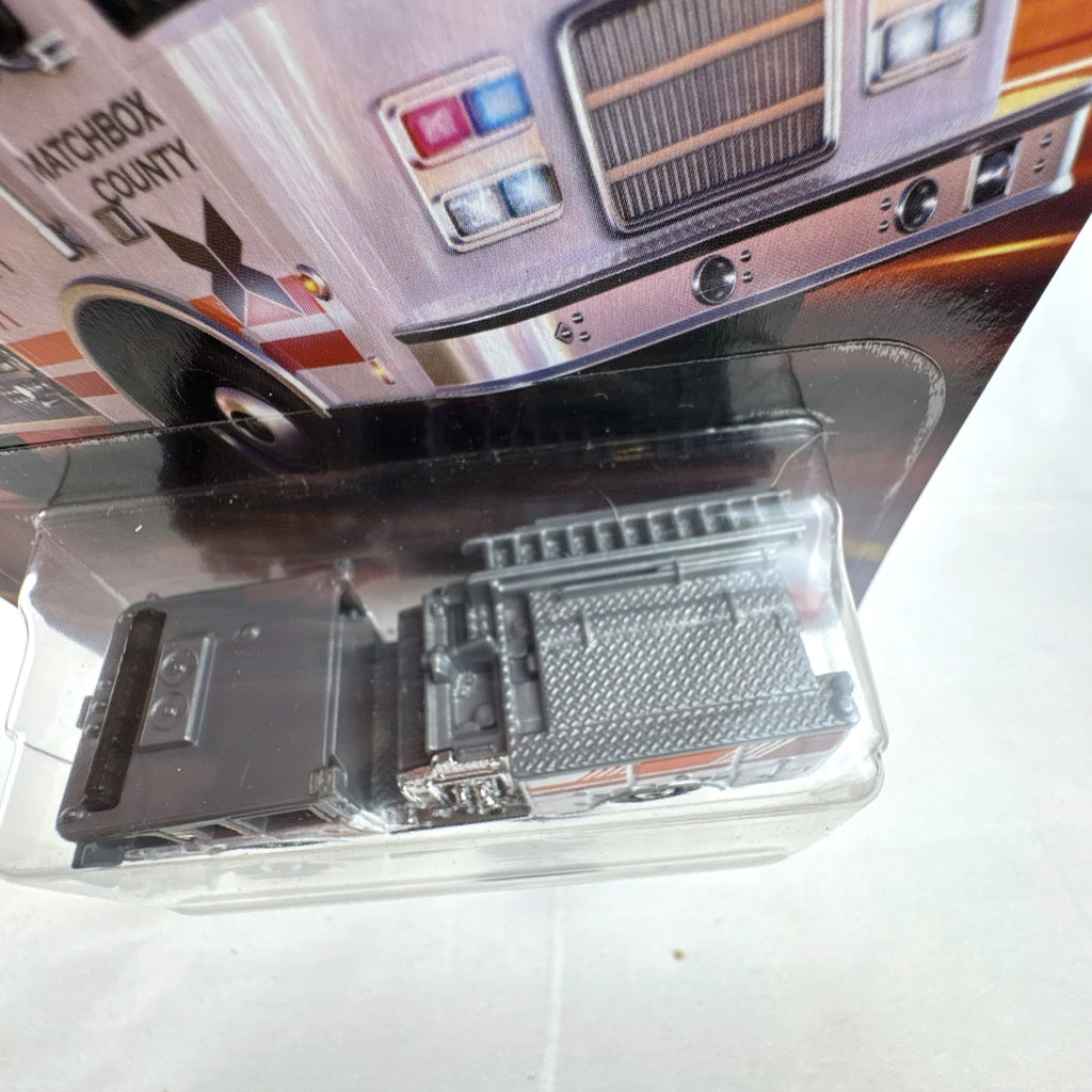 Matchbox Pierce Arrow XT Fire Engine diecast truck in white and grey, factory sealed on original card 104/125.