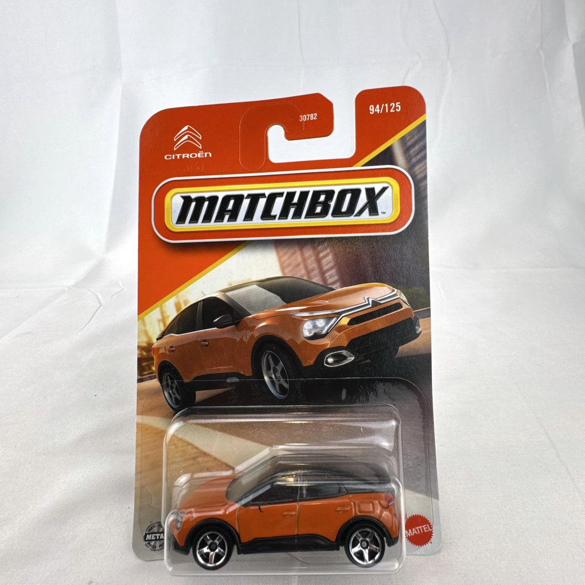 Sealed Matchbox 2023 Citroën ë-C4 1:64 scale diecast car in metallic orange on original packaging
