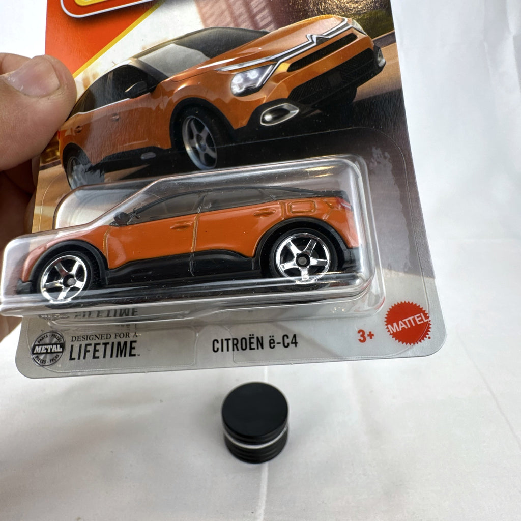 Sealed Matchbox 2023 Citroën ë-C4 1:64 scale diecast car in metallic orange on original packaging