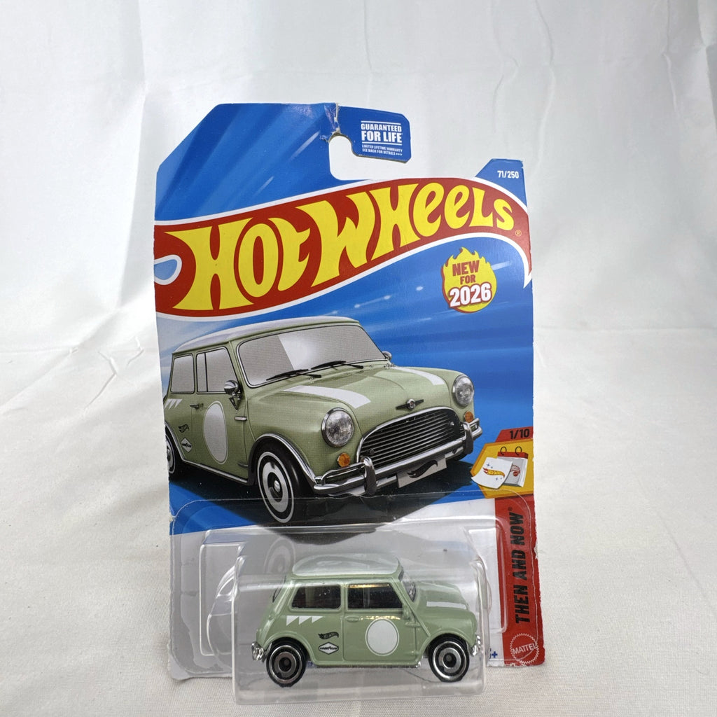 Hot Wheels 1965 Austin Mini Cooper S diecast car in sage green with white stripes, factory sealed in original packaging