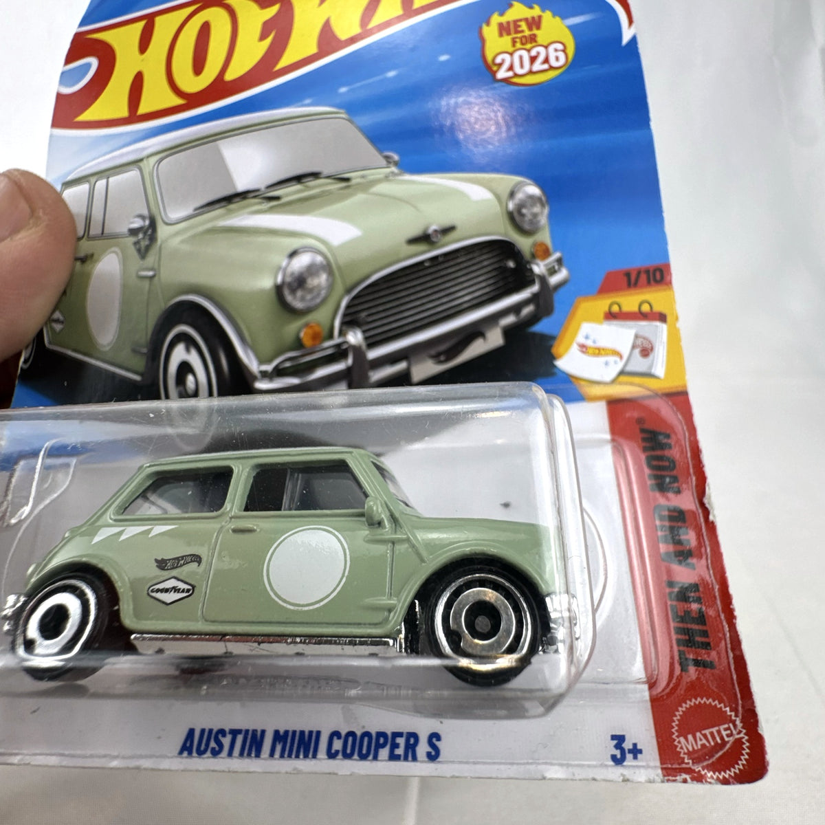 Hot Wheels 1965 Austin Mini Cooper S diecast car in sage green with white stripes, factory sealed in original packaging
