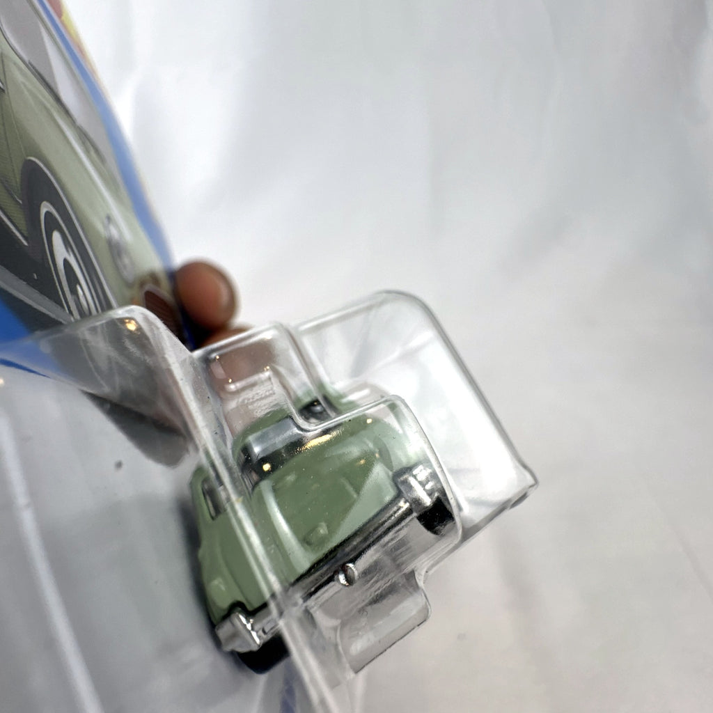 Hot Wheels 1965 Austin Mini Cooper S diecast car in sage green with white stripes, factory sealed in original packaging